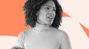 Black woman with curly hair and turtle neck shirt looking at her side as if speaking to employees with authority