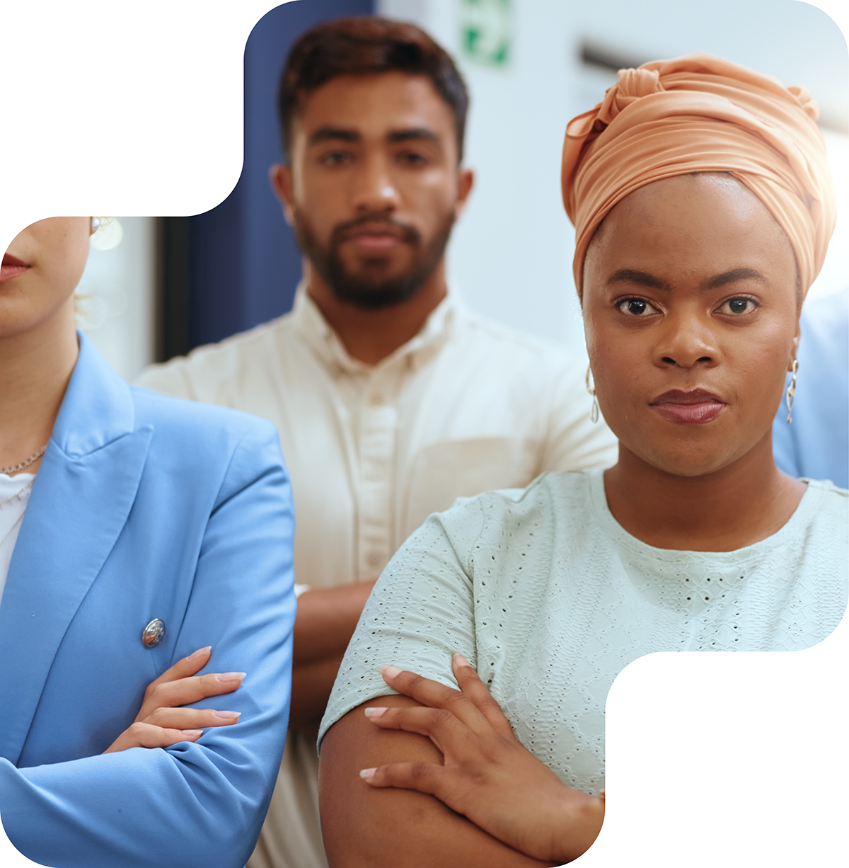 A diverse group of professionals standing confidently with arms crossed, representing strength, unity, and determination in promoting inclusion and diversity.