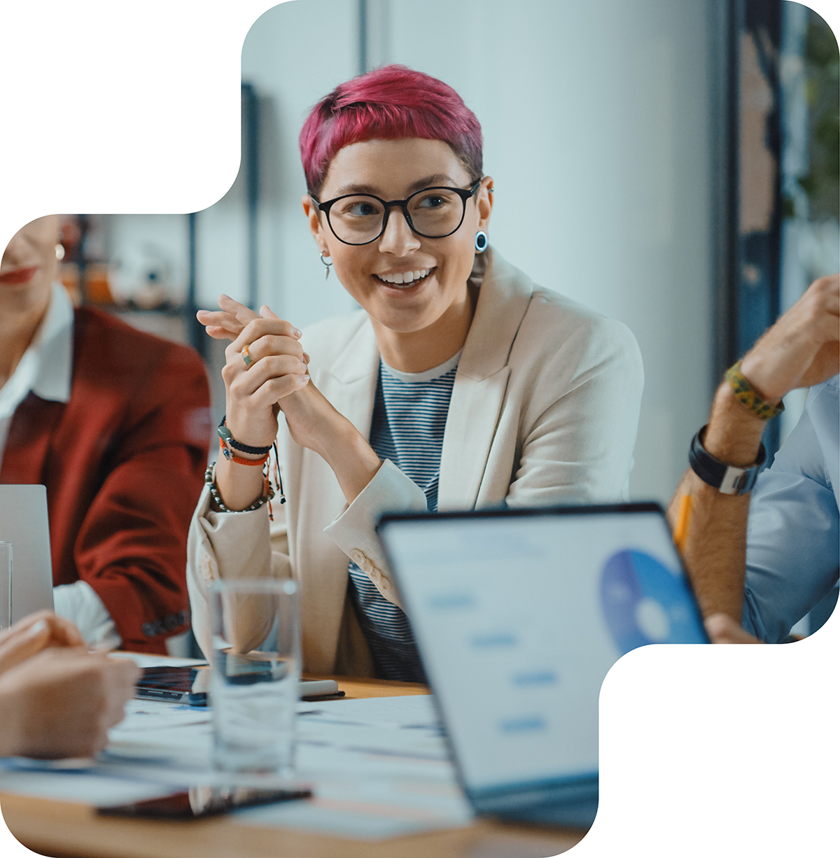 A group of professionals engaged in a lively discussion during a meeting, highlighting collaboration and active participation in the workplace.