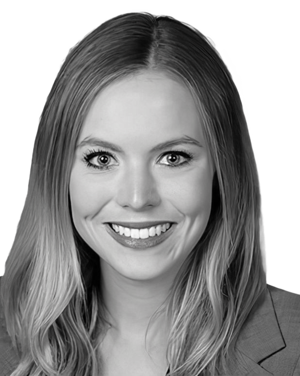 Black and white headshot of Laura McGee, the CEO of Diversio. Laura has blonde hair, and is smiling in the image.