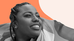 Image shows a young woman with braided hair, wearing a nose ring and earrings, smiling and looking into the distance. She appears content and optimistic. The woman is wrapped in a flag, adding a sense of pride and identity to the image.