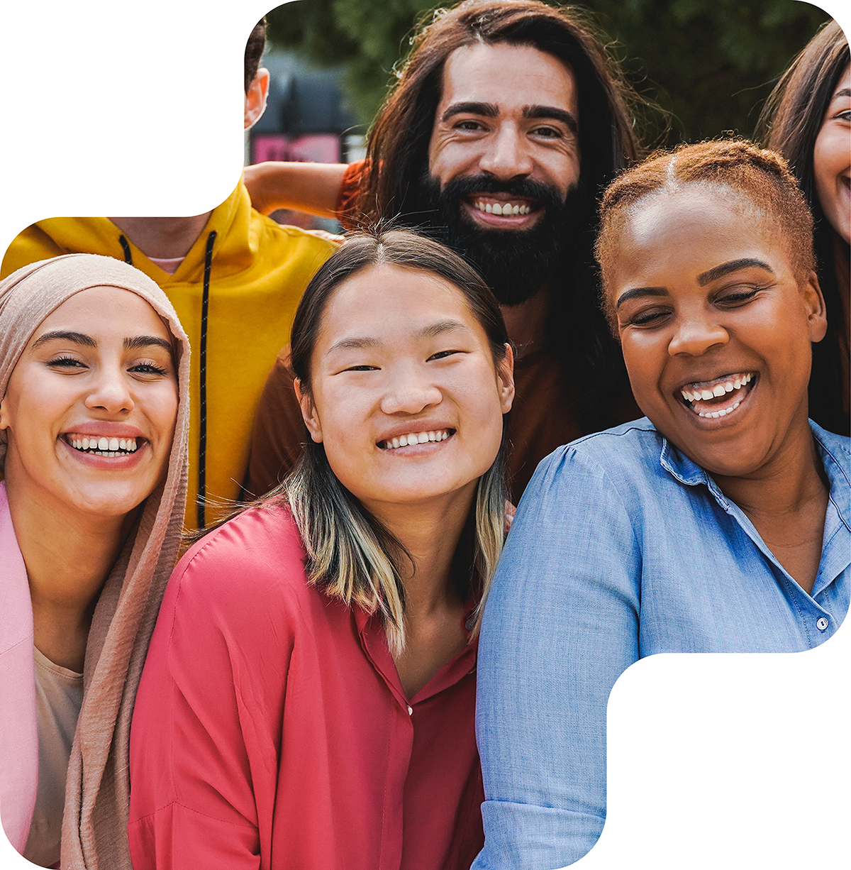 A diverse group of smiling individuals standing close together, symbolizing joy, unity, and inclusivity.