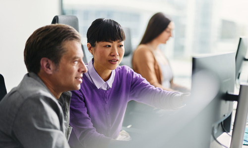 The photo shows two professionals actively looking at a screen together, which aligns with the blog’s focus on real-time insight, pulse data, and proactive engagement. It conveys analysis, collaboration, and forward thinking—perfect for the shift from passive feedback to action.