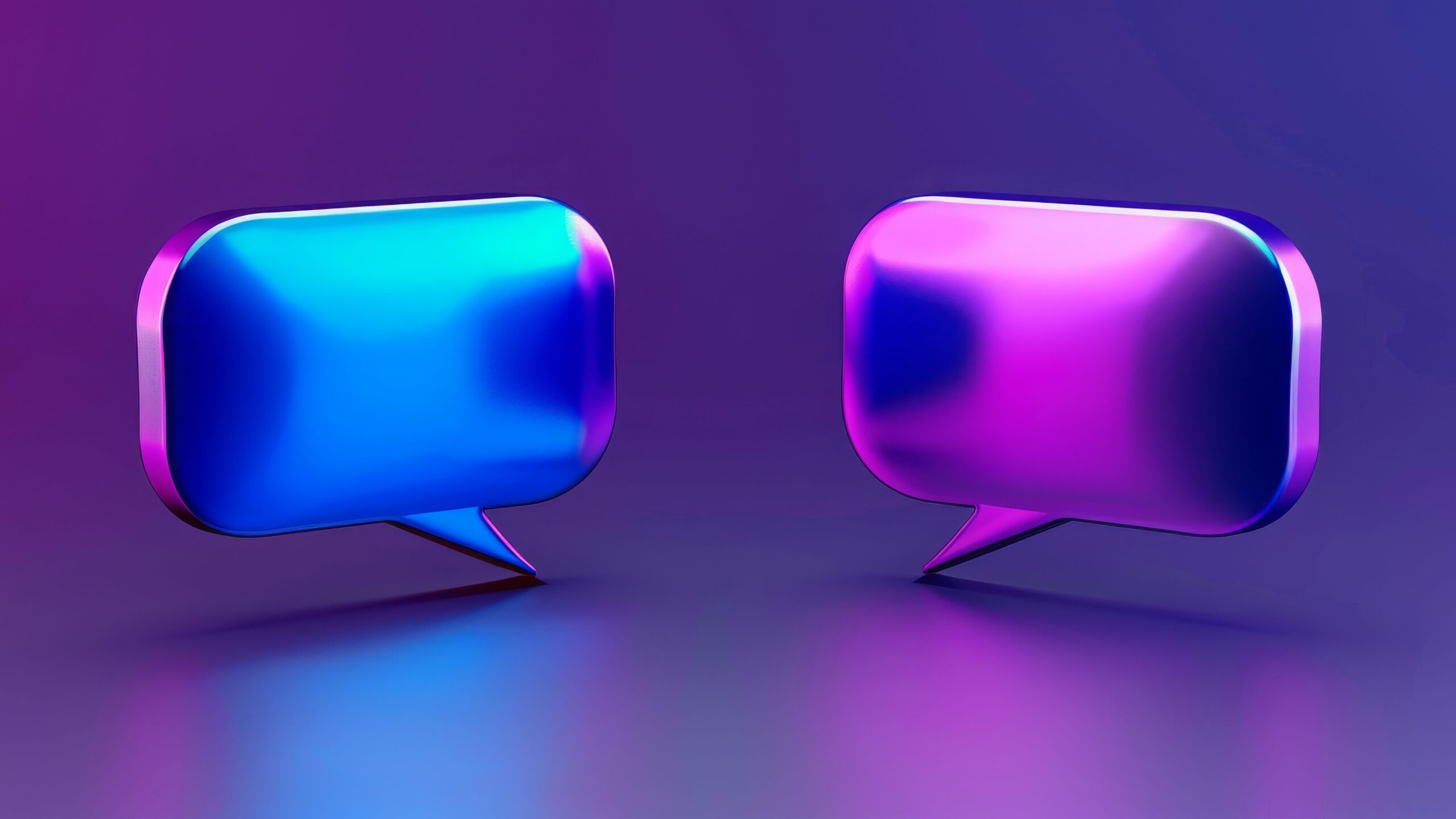 Two futuristic, colorful speech bubbles facing each other, symbolizing dialogue and communication.